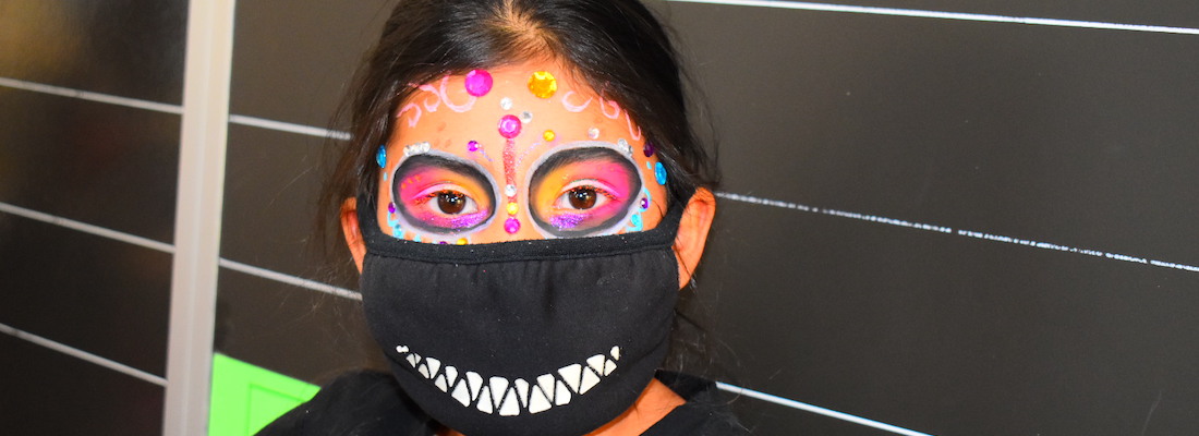 Student with face painted wearing a mask
